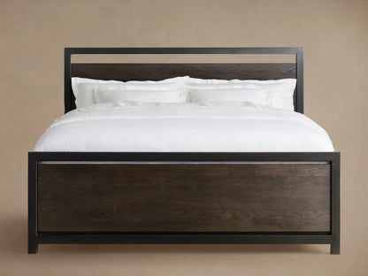 A Palmer Storage Bed with a dark wooden frame and white bedding, featuring a sleek iron headboard and footboard design.
