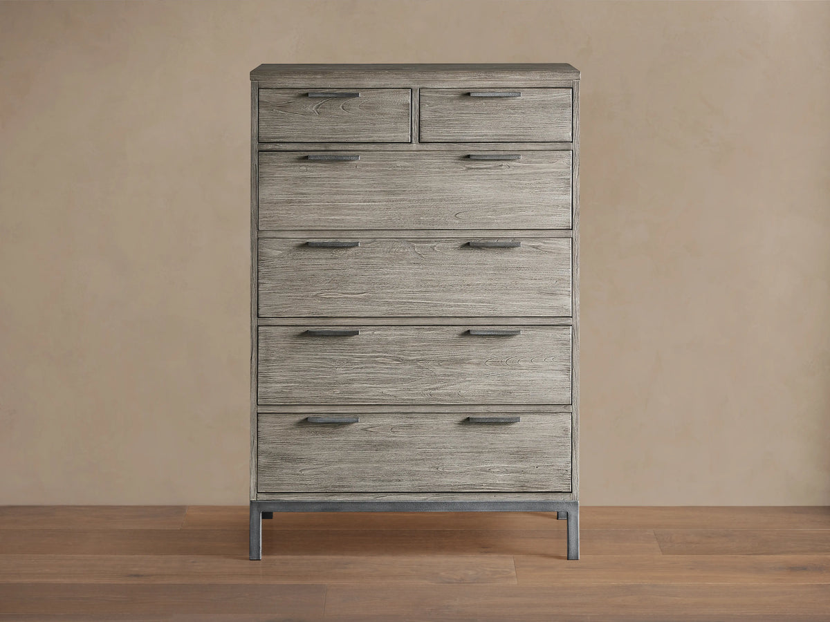 Palmer Six-Drawer Dresser in Stone on Ash finish, featuring six spacious drawers and a sleek gray metal frame, against a beige background.