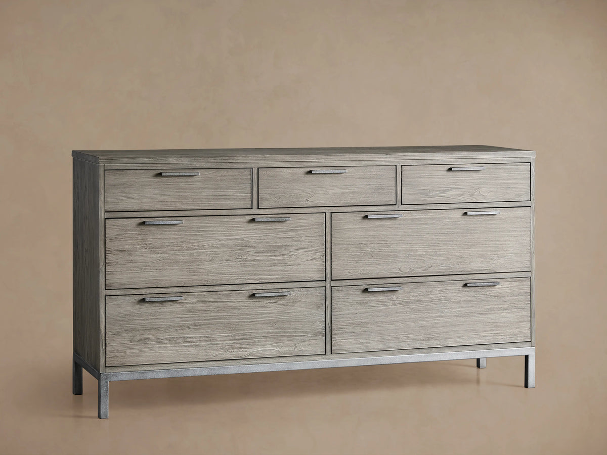 Palmer Seven-Drawer Dresser in light wood finish with sleek, horizontal handles, and a sturdy iron frame on a beige background.