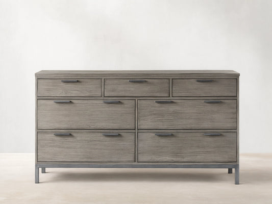 Palmer Seven-Drawer Dresser in gray wood finish, featuring a Parsons-style iron frame. Three small drawers on top, four large below.