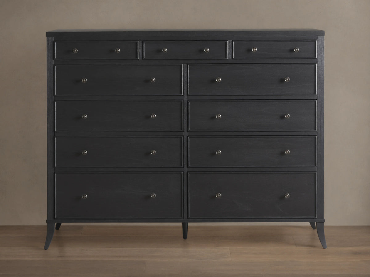 Pearson Eleven-Drawer Dresser in dark wood with hand-carved, curved molding. Features small, round handles and stands on four tapered legs.