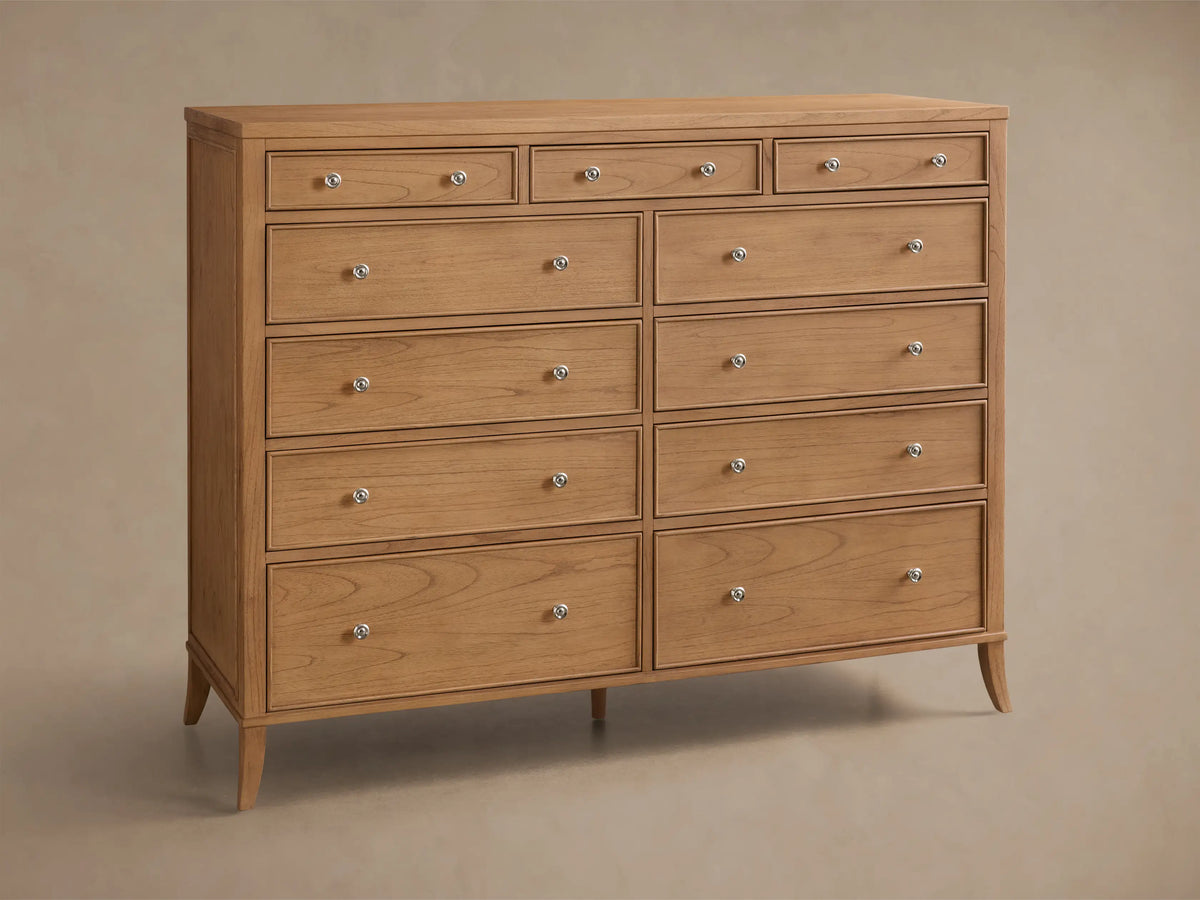 Front view of the Natural wood Pearson Eleven-Drawer Dresser, featuring eleven drawers with silver round knobs and tapered legs.
