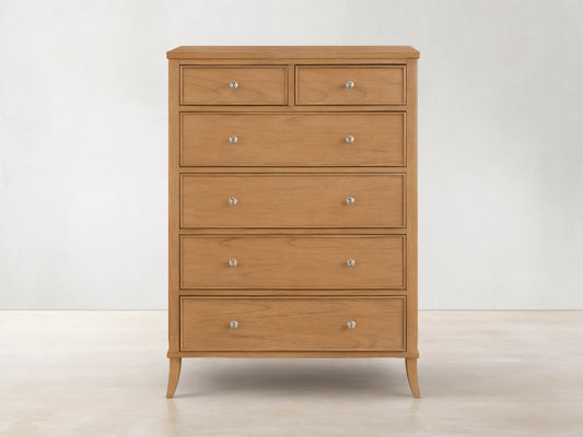 Front view of the natural wood Pearson Six-Drawer Dresser with silver knobs and curved molding on drawer fronts.