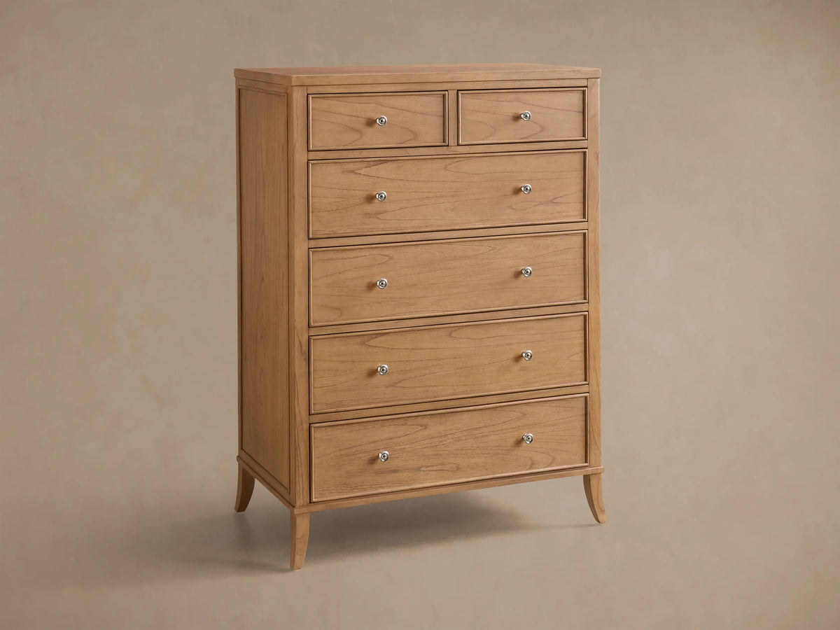 Close-up of the light brown Pearson Six-Drawer Dresser with two open drawers, showing carved molding and silver-tone knobs.