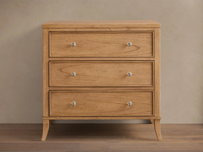 Front view of a natural wood Pearson Three-Drawer Chest with three drawers featuring hand-carved molding and round silver knobs.