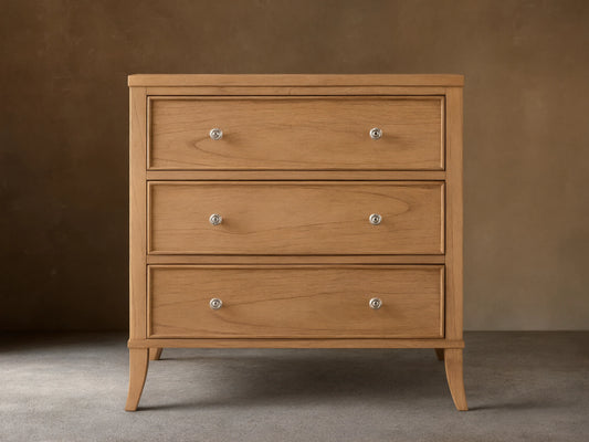 Front view of a natural wood Pearson Three-Drawer Chest with three drawers featuring hand-carved molding and round silver knobs.