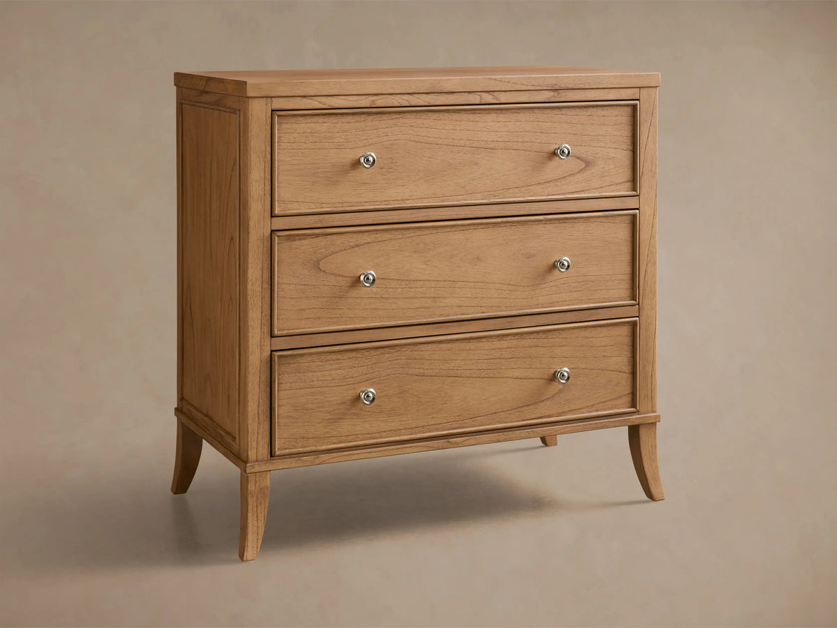 Front view of the light brown Pearson Three-Drawer Chest, featuring three drawers with silver knobs and tapered legs.