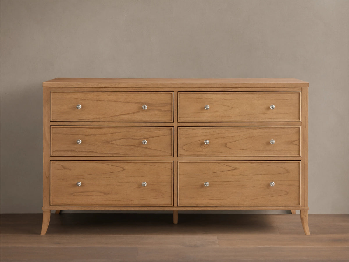 Front view of the light brown wooden Pearson Wide Six-Drawer Dresser with six drawers and silver knobs.