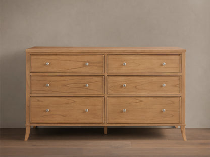 Front view of the light brown wooden Pearson Wide Six-Drawer Dresser with six drawers and silver knobs.