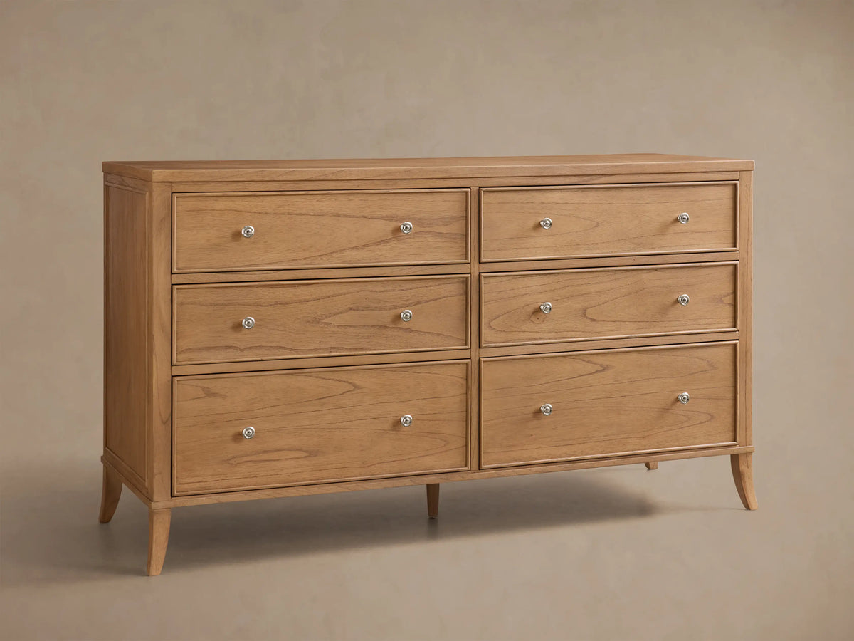 Front view of the natural mindi wood Pearson Wide Six-Drawer Dresser with six drawers, silver-toned round knobs, and tapered legs.
