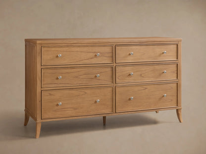Front view of the natural mindi wood Pearson Wide Six-Drawer Dresser with six drawers, silver-toned round knobs, and tapered legs.