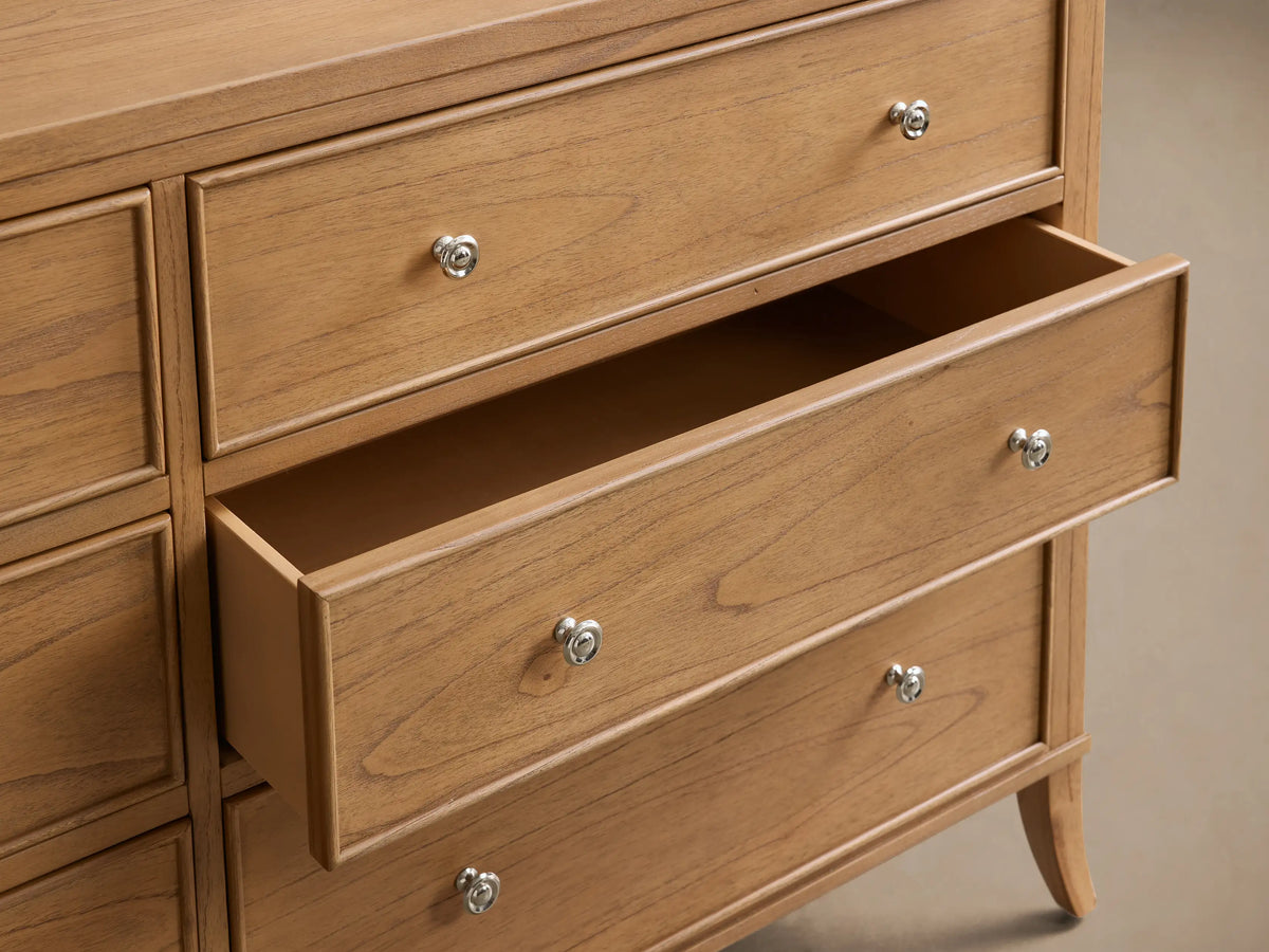 Front view of the light brown wooden Pearson Wide Six-Drawer Dresser with six drawers and silver knobs.