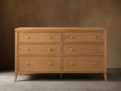 Front view of the light brown wooden Pearson Wide Six-Drawer Dresser with six drawers and silver knobs.