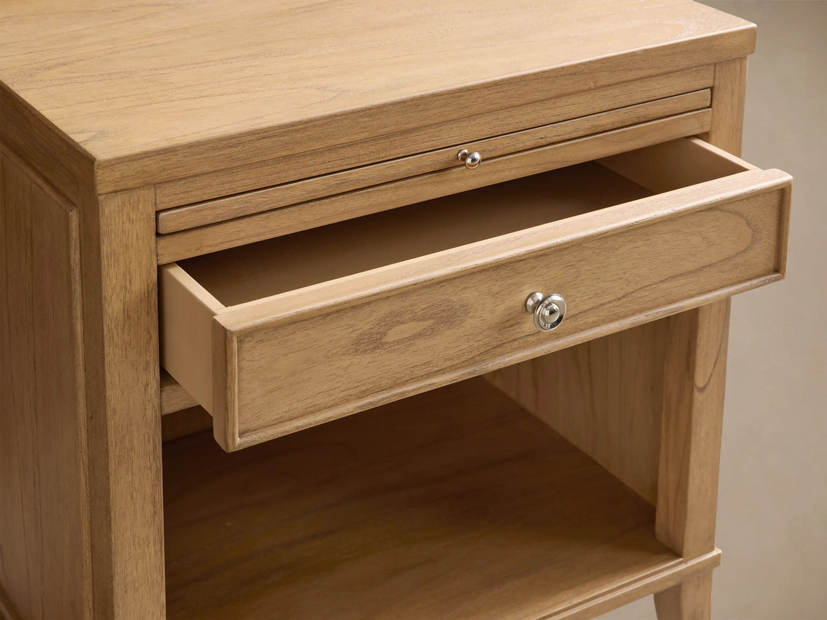Close-up of the Pearson Nightstand with its pull-out tray extended, made from light brown mindi wood, showing natural grain.