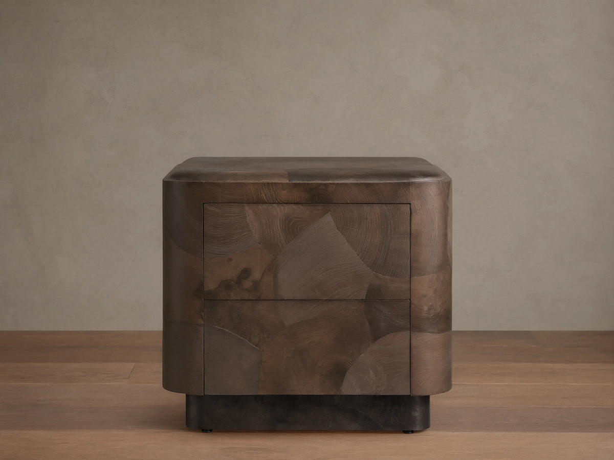 Polanco Nightstand with oyster-cut wood pattern, featuring earthy tones and cracks. Steel base, smooth drawer front, push-to-open design.