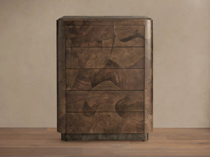 Polanco Five-Drawer Dresser made from dark oyster-cut wood with visible graining and natural patterns, and steel base with patina.