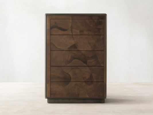Polanco Five-Drawer Dresser made from dark oyster-cut wood with visible graining and natural patterns, and steel base with patina.