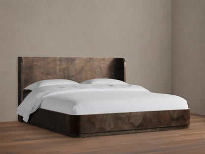 Bed made from dark wood with natural grain pattern, featuring a headboard. White bedding on a sturdy, low frame on wooden floor.