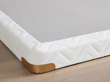 Premium 4" Platform with white quilted fabric, brass-finished metal corner guards on a wooden floor.