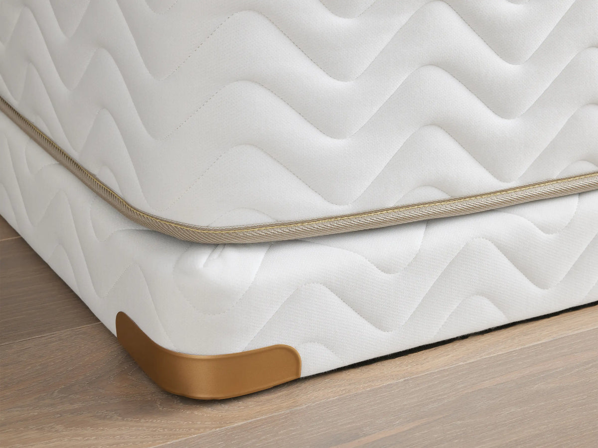 Premium 4" Platform with white quilted fabric, brass-finished metal corner guards on a wooden floor.