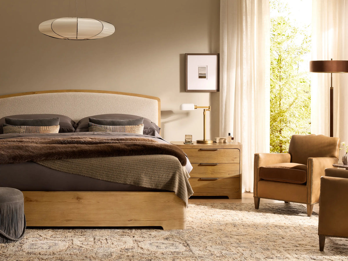 Front view of the brown Redding Nightstand, featuring three drawers with brass bar pulls, and rounded top and bottom edges.