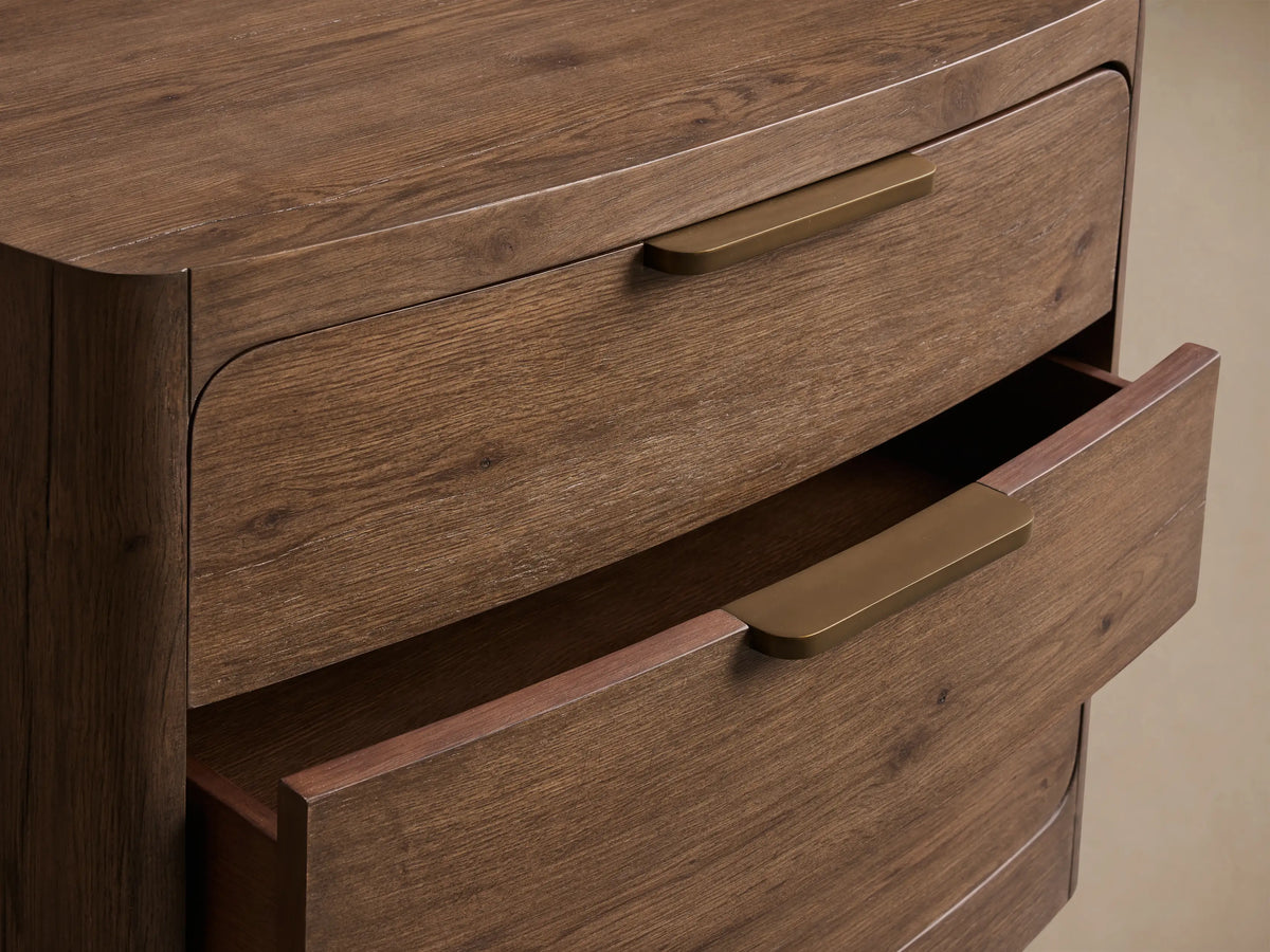 Close-up of the dark brown Redding Nightstand with two drawers, one slightly open, and long, slim, brushed gold pulls.