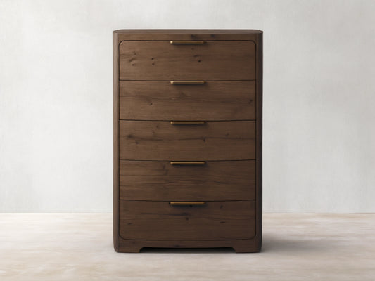 Front view of the dark brown Redding Five-Drawer Dresser, with rounded corners and antique brass handles.