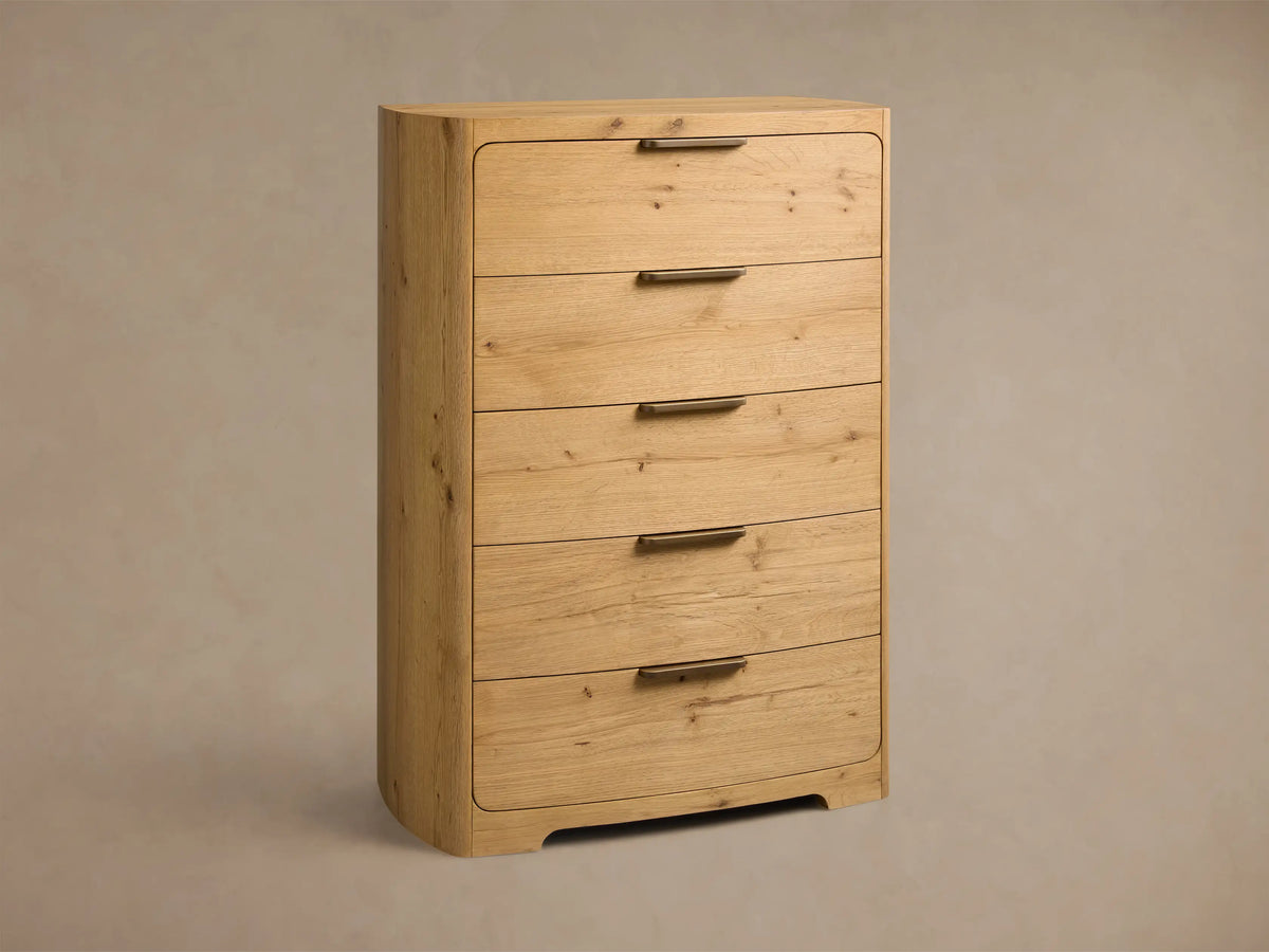 Front view of the natural oak Redding Five-Drawer Dresser with rounded corners and five drawers, each with antique brass handles.