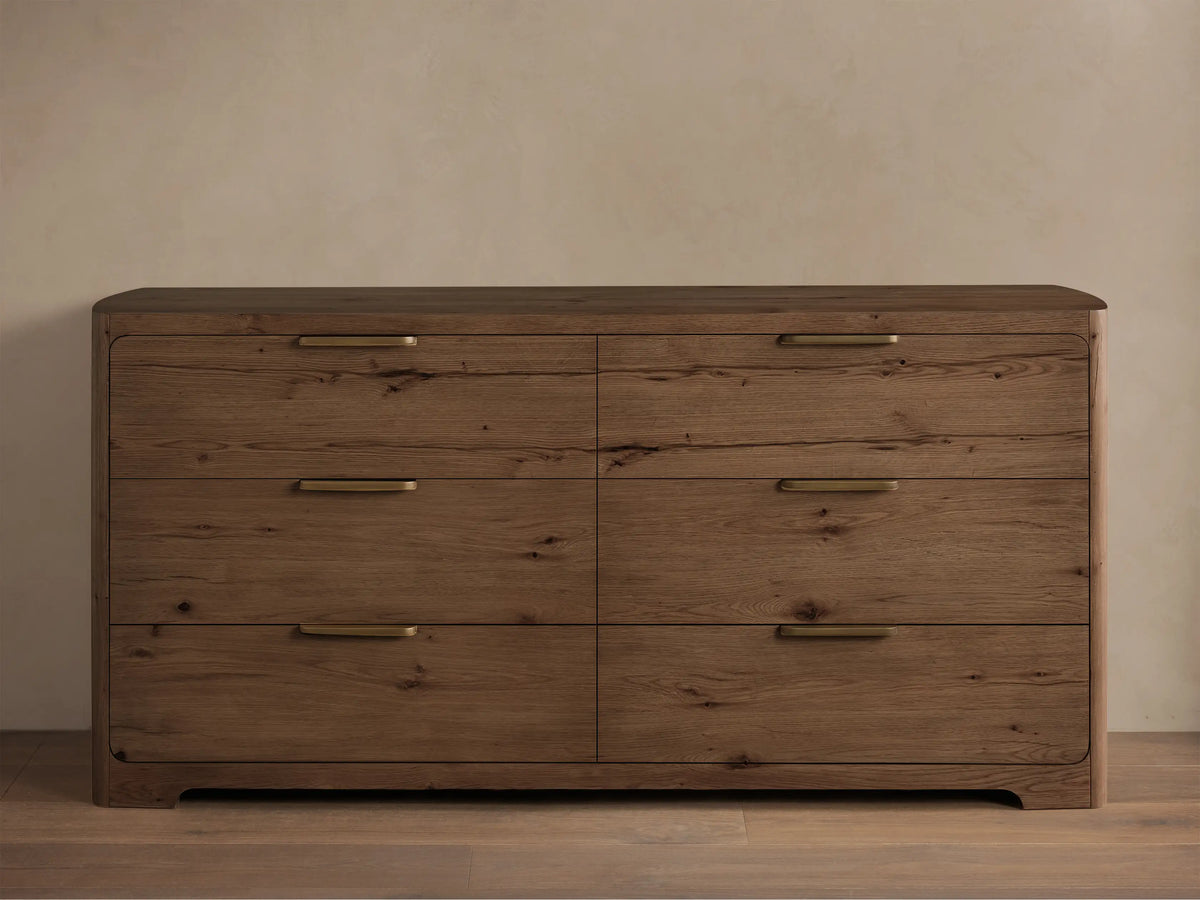 Front view of a medium-brown wood Redding Six-Drawer Dresser with six drawers, brass bar pulls, and rounded edges.
