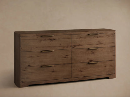 Angled front view of the Redding Six-Drawer Dresser, a medium brown wooden dresser with grain, six drawers, brass bar handles, and rounded edges.