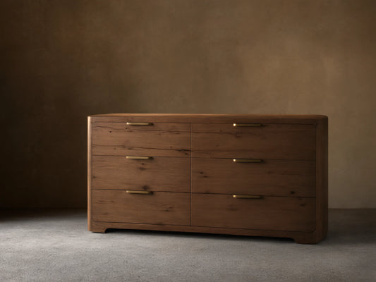Front view of a medium-brown wood Redding Six-Drawer Dresser with six drawers, brass bar pulls, and rounded edges.