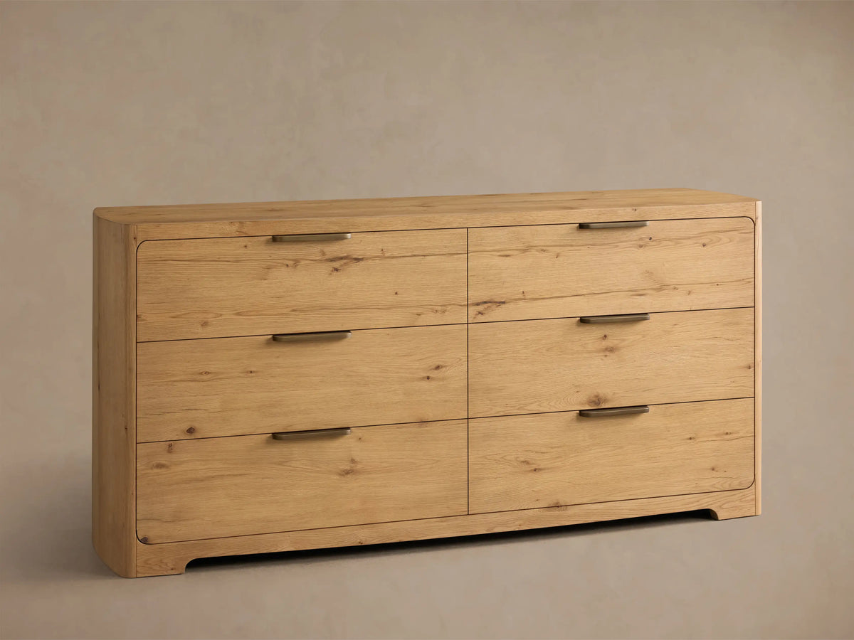 Front view of the light oak Redding Six-Drawer Dresser with rounded corners and bronze bar handles on its six drawers.