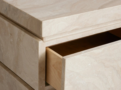 Rive Stone Nightstand: Light cream, two-drawer stone nightstand with natural veining, front-right view, on a plain beige background.