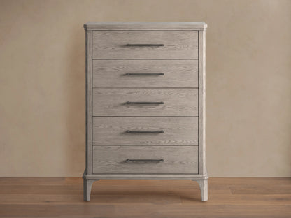 St. Martin Five-Drawer Dresser in light oak finish, features five aligned drawers with pewter handles, on a wooden floor.