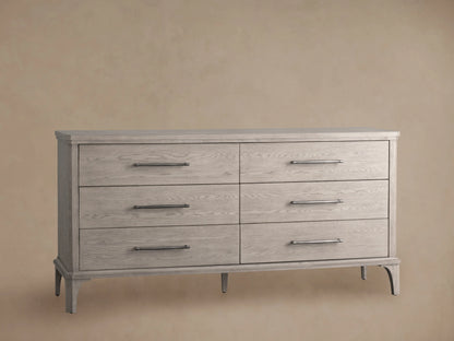 St. Martin Six-Drawer Dresser in light oak finish with six drawers and pewter-finished handles, set against a neutral wall.
