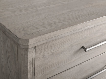 St. Martin Six-Drawer Dresser in light wood, features six drawers with pewter-finished handles, on tapered legs, against a beige background.
