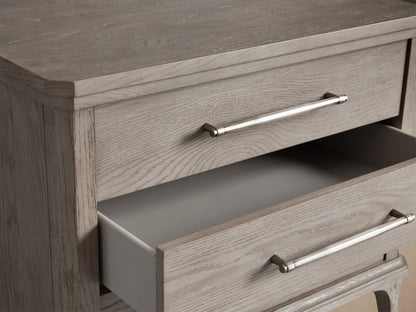 St. Martin Closed Nightstand in light oak, featuring three drawers with pewter-finished handles and elegant tapered legs.