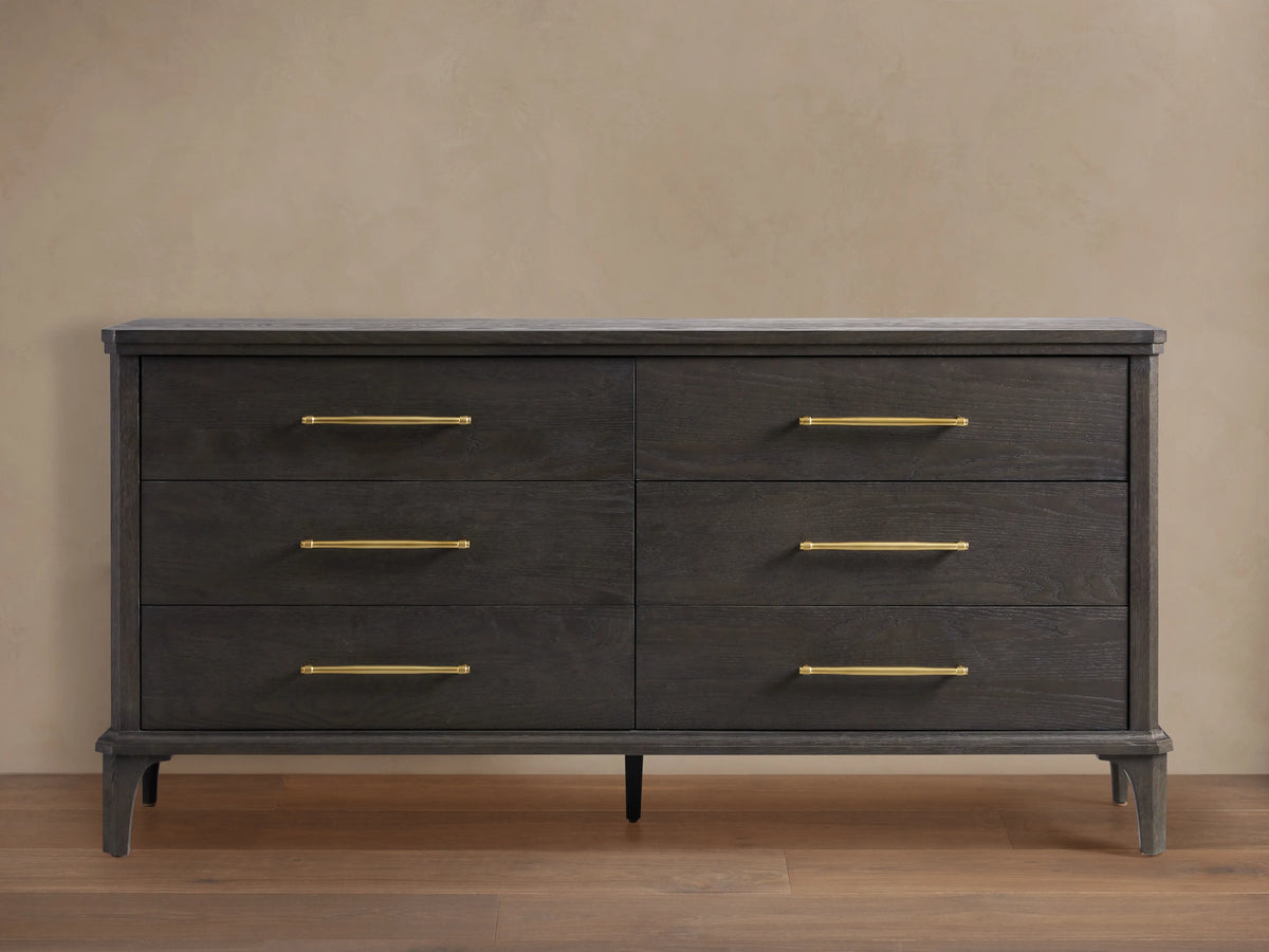 St. Martin Six-Drawer Dresser in smoke-finished oak, six drawers with brass-finished bar pulls, front view against a light wall.
