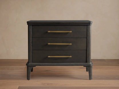 St. Martin Closed Nightstand shown in dark oak finish with three drawers. Brass-finished handles complement its craftsman design.