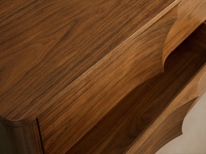 Westyn Six-Drawer Dresser: Warm brown walnut wood with 6 drawers, featuring unique carved, concave wave-like fronts.