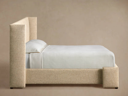Close-up of the light beige textured upholstery on the Wyller Bed headboard.