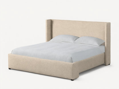 Front view of the beige upholstered Wyller Bed featuring an angled wingback headboard, made with white bedding.