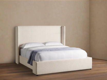 Wyller Bed with tall, cream upholstered headboard & frame, white bedding & light blue throw on wood floor.