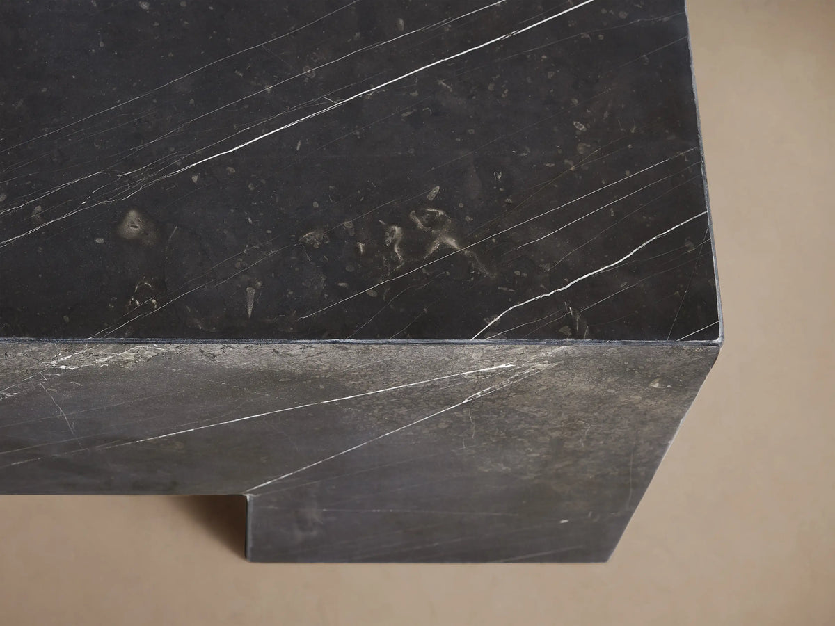 Square Brooklyn Coffee Table, dark gray Black Marquina marble, low profile, block legs, prominent white veining, on wood floor.