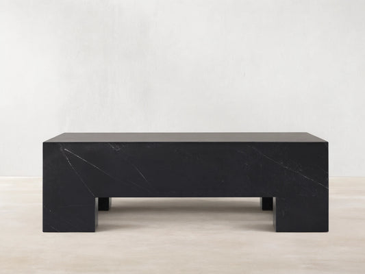 Brooklyn Coffee Table, rectangular block of dark black Marquina marble with white veining on a wooden floor.