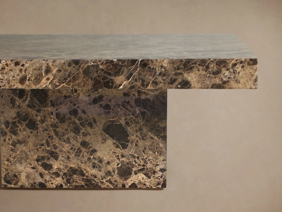 Matteo Square Coffee Table in Emperador. Square dark marble table with gold veining, solid block base, on wooden floor.