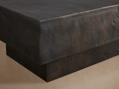 Sydney Coffee Table with a rectangular block design, dark textured finish, and minimalist style, set on a wooden floor.