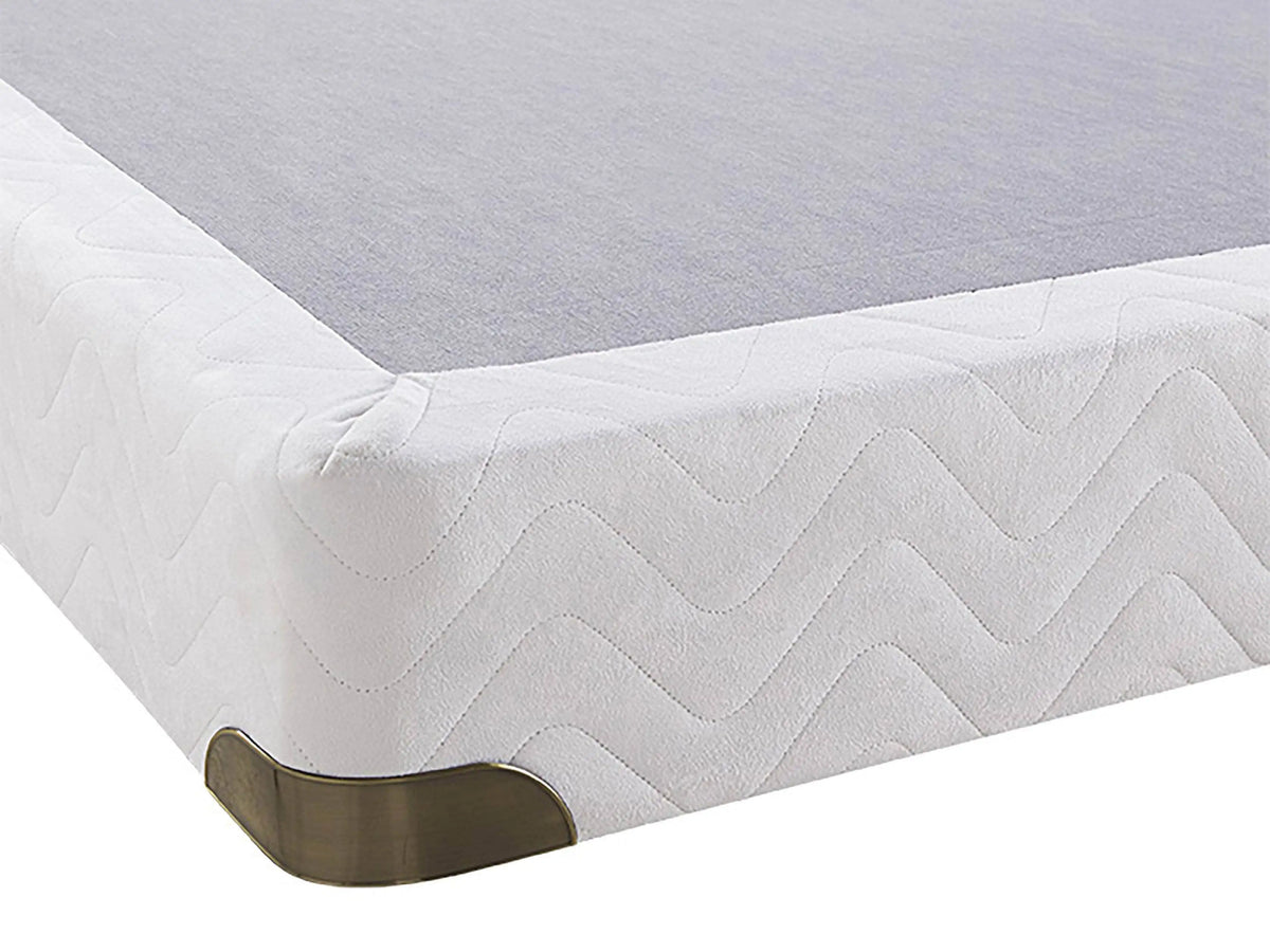 Retreat 8" Box Spring with white zigzag-patterned fabric and metal corner guards, shown from a corner angle.