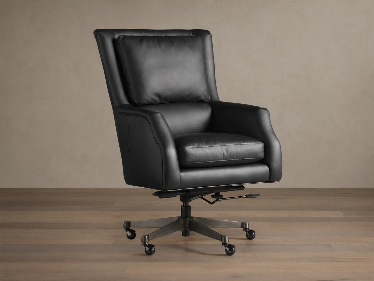 Alex Leather Desk Chair in black leather upholstery on casters, with adjustable armrests and backrest, set on a wooden floor.