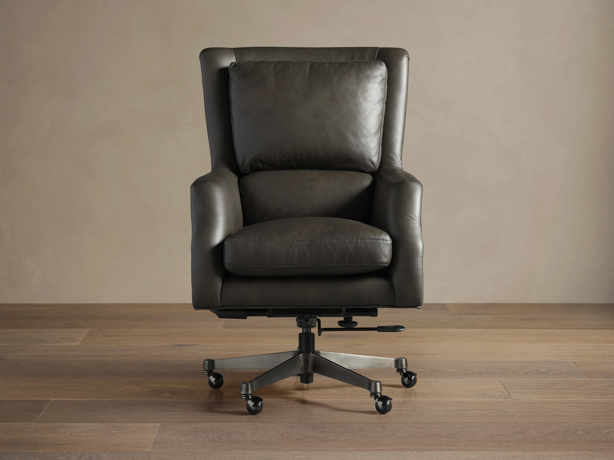 Alex Leather Desk Chair, dark gray leather, high back with cushion, armrests, 5-star swivel base with casters, angled.